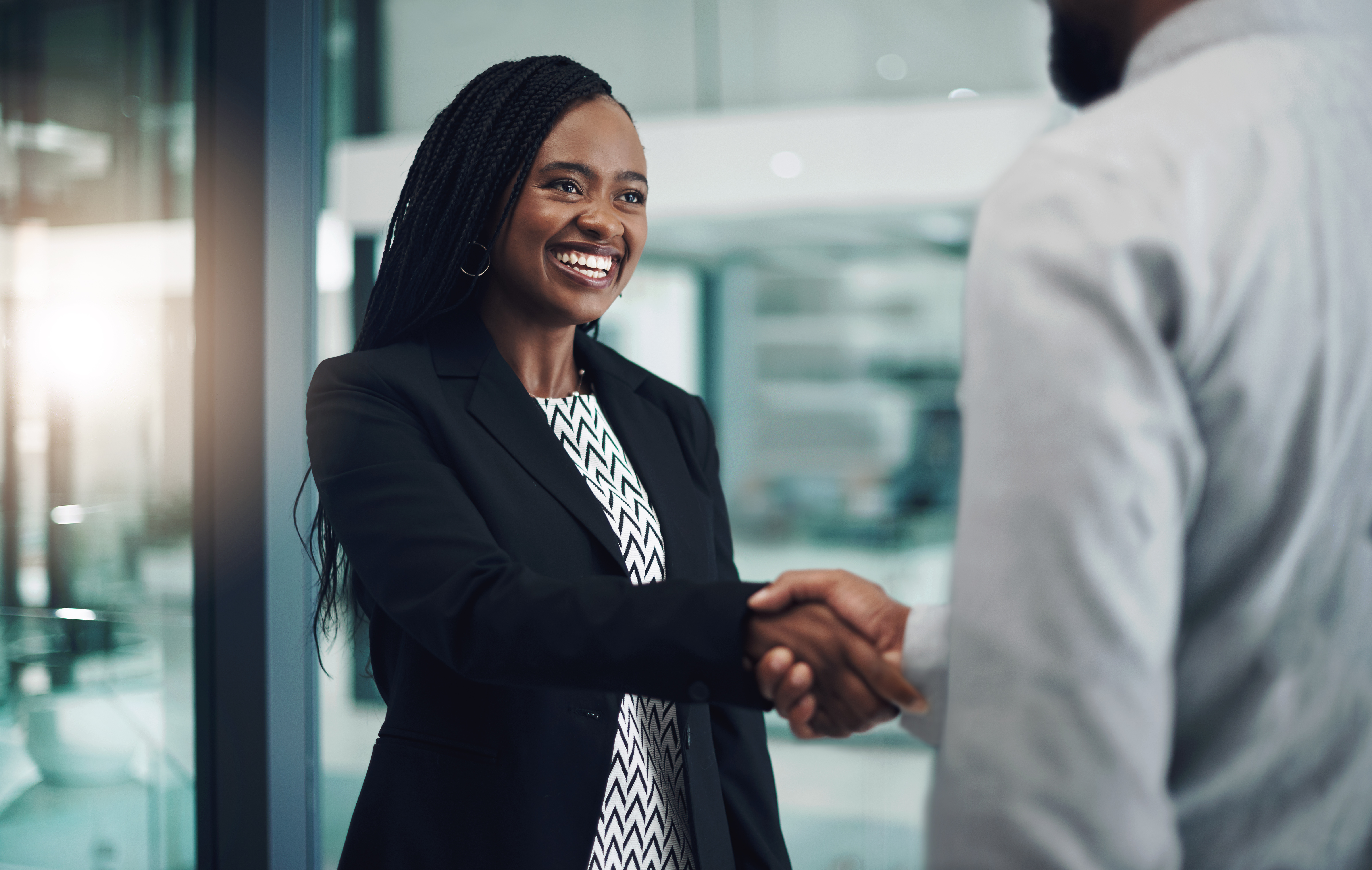Businesswoman shakes hands with a colleague
